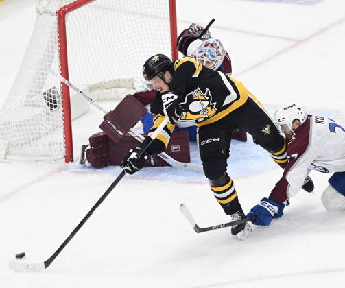 Pittsburgh Penguins right wing Rickard Rakell (67) attempts a backhanded shot on Colorado Avalanche goaltender Scott Wedgewood (41) during the second period at PPG Paints Arena in Pittsburgh on Tuesday, March 24, 2026. PIT2026032413 ARCHIExCARPENTER