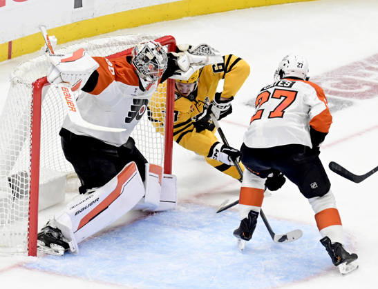 Pittsburgh Penguins right wing Rickard Rakell (67) watches as Pittsburgh Penguins defenseman Kris Letang shot finds the goal behind the skate of Philadelphia Flyers goaltender Dan Vladar (80) during the second period of the Penguins 3-2 win in the opening round of the Eastern Conference playoffs at PPG Paints Arena in Pittsburgh on Monday, April 27, 2026. PIT2026042714 ARCHIExCARPENTER