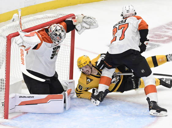 Pittsburgh Penguins right wing Rickard Rakell (67) falls to the ice as Pittsburgh Penguins defenseman Kris Letang shot finds the goal behind the skate of Philadelphia Flyers goaltender Dan Vladar (80) during the second period of the Pittsburgh Penguins 3-2 win in the opening round of the Eastern Conference playoffs at PPG Paints Arena in Pittsburgh on Monday, April 27, 2026. PIT2026042715 ARCHIExCARPENTER