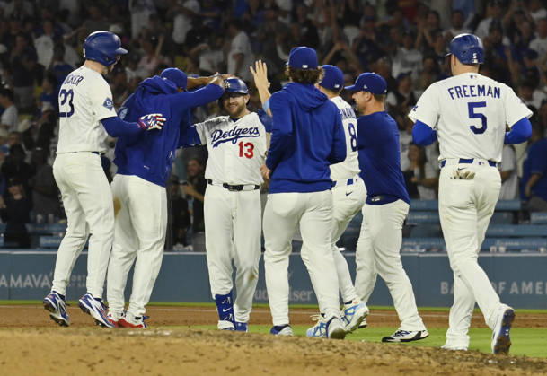 Los Angeles Dodgers Max Muncy (13) celebrates with teammates after hitting a walk-off RBI single in the tenth inning against the Kansas City Royals at Dodger Stadium in Los Angeles on Tuesday, August 11, 2026. LAP2026081101 JIMxRUYMEN