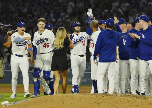 Los Angeles Dodgers Max Muncy (13) celebrates with teammates after hitting a walk-off RBI single in the tenth inning against the Kansas City Royals at Dodger Stadium in Los Angeles on Tuesday, August 11, 2026.  LAP2026081102 JIMxRUYMEN