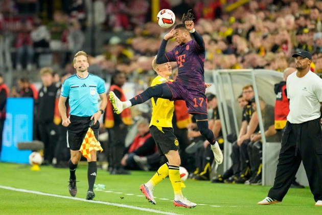 Daniel Svensson (Borussia Dortmund) und Michael Olise (FC Bayern Muenchen) battle for the ball during the Franz Beckenbauer Supercup match between Borussia Dortmund and FC Bayern Muenchen at Signal Iduna Park on August 22, 2026 in Dortmund, Germany. (Photo by Alex Gottschalk DeFodi Images) -