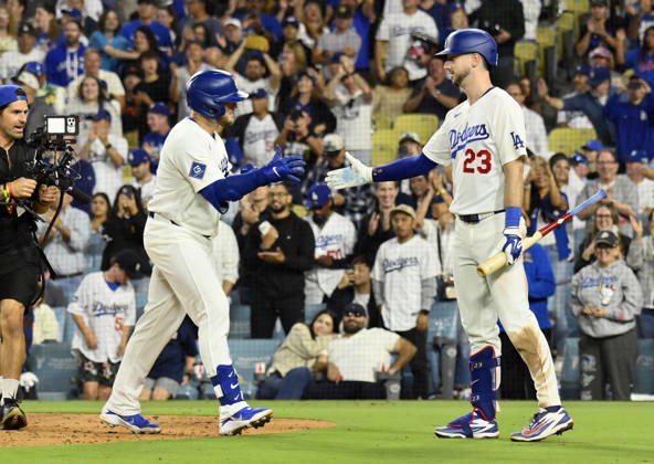 Los Angeles Dodgers Max Muncie celebrates with Kyle Tucker (23) after hitting a solo home run against the San Francisco Giants in a five-run eighth inning at Dodger Stadium in Los Angeles on Friday, September 18, 2026. The Dodgers defeated the Giants 8-2.  LAP2026091803 JIMxRUYMEN