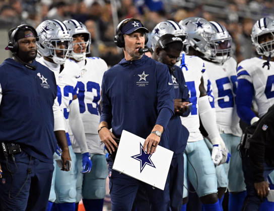 Dallas Cowboys head coach Berian Schottenheimer calls plays against the Tampa Bay Buccaneers during their game at AT&T Stadium in Arlington, Texas on Thursday, October 8, 2026.  ARL2026100817 IANxHALPERIN