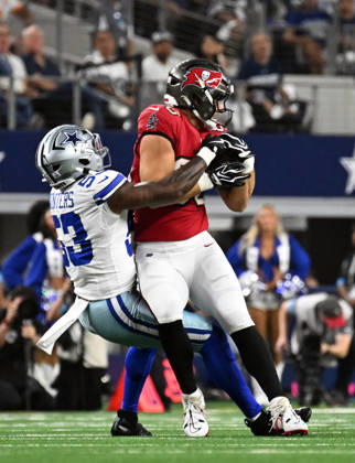 Tampa Bay Buccaneers Cade Otton gets wrapped by Dallas Cowboys Dee Winter after a short catch during their game at AT&T Stadium in Arlington, Texas on Thursday, October 8, 2026.  ARL2026100819 IANxHALPERIN