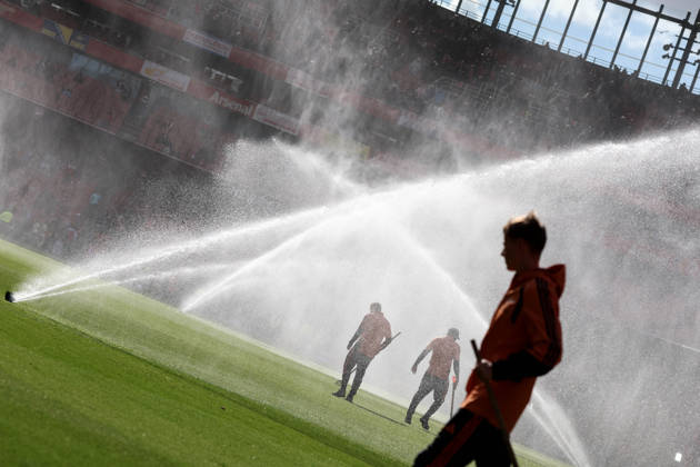 Arsenal v Leeds United 10 October 2026, London - Premier League Football - Arsenal v Leeds United - Groundskeepers stand amongst the pitch sprinklers - Photo: Charlotte Wilson Offside. London UK Copyright: xCharlottexWilsonx xOffsidexOffside