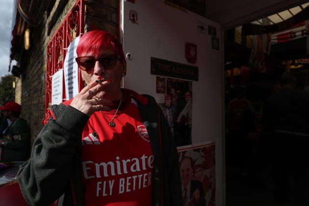 Arsenal v Leeds United 10 October 2026, London - Premier League Football - Arsenal v Leeds United - An Arsenal fan smokes a cigarette - Photo: Charlotte Wilson Offside. London UK Copyright: xCharlottexWilsonx xOffsidexOffside