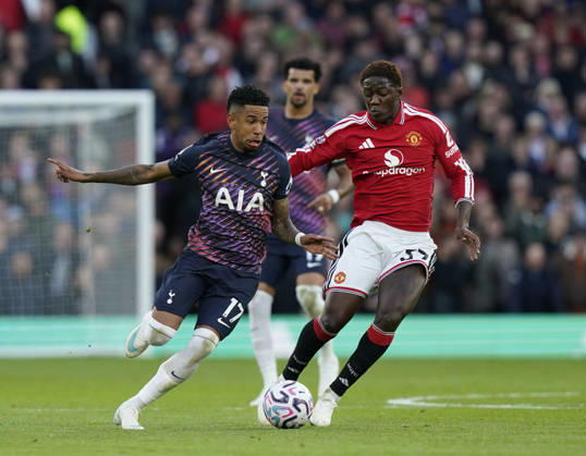 Manchester, England, 10th October 2026. Savio of Tottenham tussles with Kobbie Mainoo of Manchester United, ManU during the Manchester United vs Tottenham Hotspur Premier League match at Old Trafford, Manchester. Picture credit should read: Andrew Yates Sportimage EDITORIAL USE ONLY. No use with unauthorised audio, video, data, fixture lists, club league logos or live services. Online in-match use limited to 120 images, no video emulation. No use in betting, games or single club league player publications. SPI_024_AY_MANUTD_SPURS SPI-5058-0024