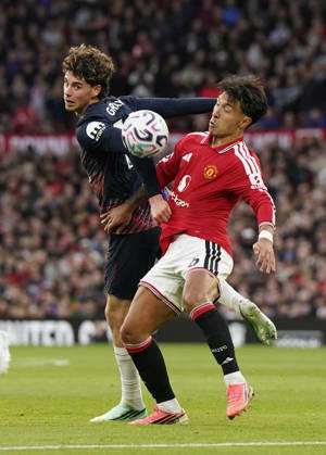 Manchester, England, 10th October 2026. Archie Gray of Tottenham tussles with Lisandro Martinez of Manchester United, ManU during the Manchester United vs Tottenham Hotspur Premier League match at Old Trafford, Manchester. Picture credit should read: Andrew Yates Sportimage EDITORIAL USE ONLY. No use with unauthorised audio, video, data, fixture lists, club league logos or live services. Online in-match use limited to 120 images, no video emulation. No use in betting, games or single club league player publications. SPI_031_AY_MANUTD_SPURS SPI-5058-0031