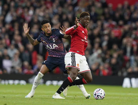 Manchester, England, 10th October 2026. Savio of Tottenham tackles Kobbie Mainoo of Manchester United, ManU during the Manchester United vs Tottenham Hotspur Premier League match at Old Trafford, Manchester. Picture credit should read: Andrew Yates Sportimage EDITORIAL USE ONLY. No use with unauthorised audio, video, data, fixture lists, club league logos or live services. Online in-match use limited to 120 images, no video emulation. No use in betting, games or single club league player publications. SPI_037_AY_MANUTD_SPURS SPI-5058-0037