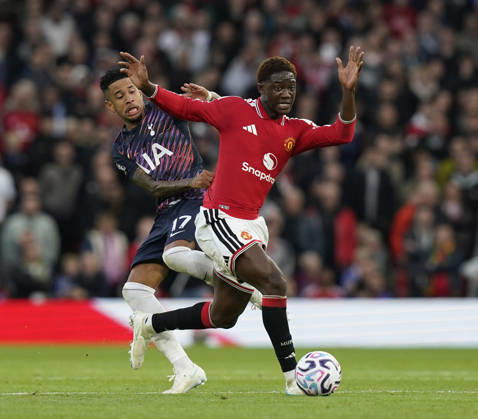 Manchester, England, 10th October 2026. Savio of Tottenham tackles Kobbie Mainoo of Manchester United, ManU during the Manchester United vs Tottenham Hotspur Premier League match at Old Trafford, Manchester. Picture credit should read: Andrew Yates Sportimage EDITORIAL USE ONLY. No use with unauthorised audio, video, data, fixture lists, club league logos or live services. Online in-match use limited to 120 images, no video emulation. No use in betting, games or single club league player publications. SPI_039_AY_MANUTD_SPURS SPI-5058-0039