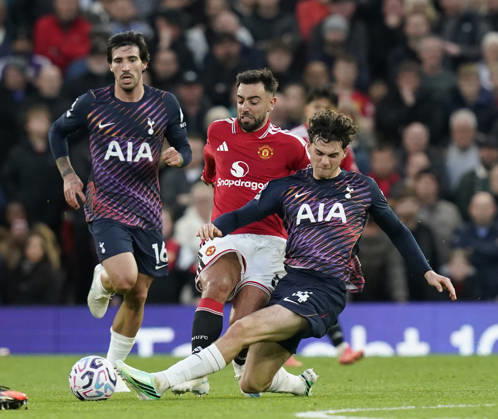 Manchester, England, 10th October 2026. Bruno Fernandes of Manchester United, ManU tackled by Archie Gray of Tottenham during the Manchester United vs Tottenham Hotspur Premier League match at Old Trafford, Manchester. Picture credit should read: Andrew Yates Sportimage EDITORIAL USE ONLY. No use with unauthorised audio, video, data, fixture lists, club league logos or live services. Online in-match use limited to 120 images, no video emulation. No use in betting, games or single club league player publications. SPI_042_AY_MANUTD_SPURS SPI-5058-0042