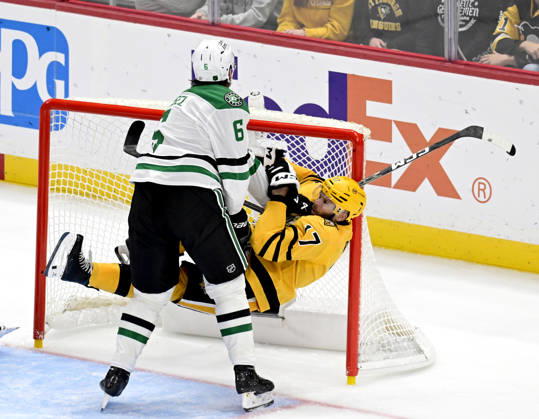 Dallas Stars defenseman Lian Bichsel (6) receives an interference penalty as he pushes Pittsburgh Penguins right wing Bryan Rust (17) into the goal during the third period at PPG Paints Arena in Pittsburgh on Saturday, October, 10 2026. The Pittsburgh Penguins went on to win 2-1 in a shootout.  PIT2026101021 ARCHIExCARPENTER