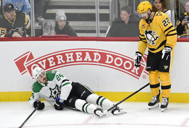 Pittsburgh Penguins center Hendrix Lapierre (22) receives a tripping penalty and looks at his stick caught in the blade of Dallas Stars center Roope Hintz (24) skate during the third period at PPG Paints Arena in Pittsburgh on Saturday, October, 10 2026. The Pittsburgh Penguins went on to win 2-1 in a shootout.  PIT2026101022 ARCHIExCARPENTER
