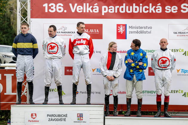 The 136th Grand Pardubice Steeplechase (6,900m), in Pardubice, Czech Republic, on October 11, 2026. From left: Winner Keith Michael Donoghue (Final Orders), the second placed Jan Faltejsek (Godfrey), the third Jan Odlozil (Angkor Wat), the fourth Lenka Neprasova (Sacamiro), the fifth James Best (Greek Dessert), and the sixth Ondrej Velek (High in the Sky) on the podium. (CTKxPhoto DavidxTanecek) CTKPhotoP2026101105417 CTKPhotoP2026101105417
