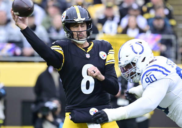 Pittsburgh Steelers quarterback Aaron Rodgers (8) is hit hard by Indianapolis Colts defensive tackle Grover Stewart (90) after throwing to Pittsburgh Steelers running back Jaylen Warren that makes the catch and runs 80 yards for a touchdown in the first quarter at Acrisure Stadium on Sunday, October 11, 2026 in Pittsburgh.  PIT2026101101 ARCHIExCARPENTER
