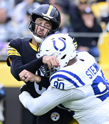 Pittsburgh Steelers quarterback Aaron Rodgers (8) is hit hard by Indianapolis Colts defensive tackle Grover Stewart (90) after throwing to Pittsburgh Steelers running back Jaylen Warren that makes the catch and runs 80 yards for a touchdown in the first quarter at Acrisure Stadium on Sunday, October 11, 2026 in Pittsburgh.  PIT2026101102 ARCHIExCARPENTER