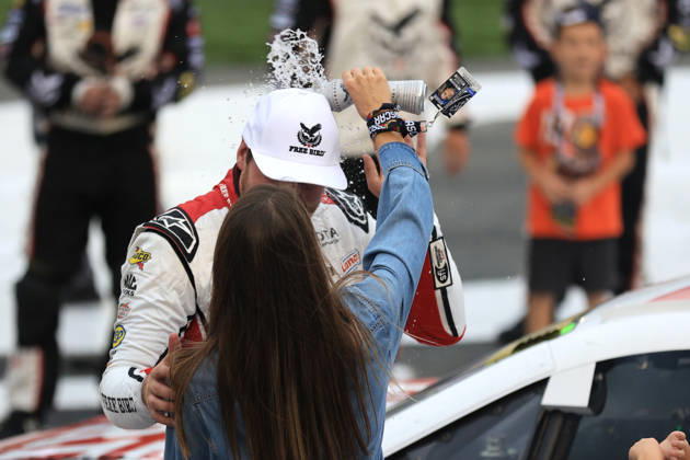CHARLOTTE, NC - OCTOBER 11: Chase Briscoe ( 19 Joe Gibbs Racing Freebird Spring Water Toyota) celebrates as his wife Marissa pours water on his head after winning the NASCAR, Motorsport, USA Cup Series Playoffs Bank of America 400 race on October 11, 2026 at Charlotte Motor Speedway in Charlotte, NC. (Photo by Jeff Robinson Icon Sportswire) AUTO: OCT 11 NASCAR Cup Series Playoffs Bank of America 400 EDITORIAL USE ONLY Icon2610111024400