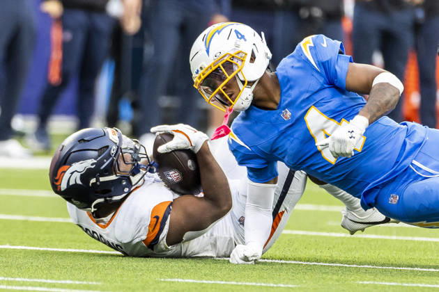 October 11, 2026, Inglewood, California, USA: Denver Broncos Running Back J.K. Dobbins (27) is tackled by Los Angeles Chargers cornerback Tarheeb Still (4) during an NFL, American Football Herren, USA football game, in Inglewood, Calif. on Sunday Oct. 11, 2026. Inglewood USA - ZUMAc68_ 20261011_zaf_c68_021 Copyright: xRingoxChiux