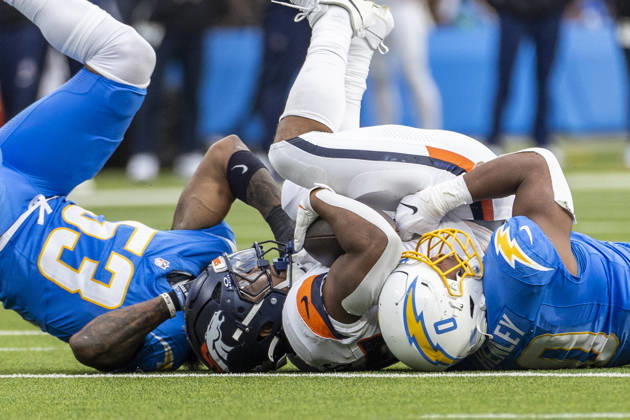 October 11, 2026, Inglewood, California, USA: Denver Broncos Running Back J.K. Dobbins (27) is brought down by Los Angeles Chargers linebacker sDel Shawn Phillips (53) and Daiyan Henley (0) during an NFL, American Football Herren, USA football game, in Inglewood, Calif. on Sunday Oct. 11, 2026. Inglewood USA - ZUMAc68_ 20261011_zaf_c68_022 Copyright: xRingoxChiux