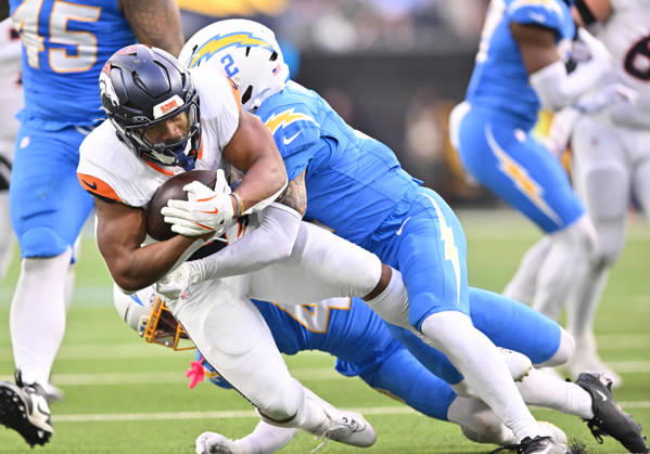 INGLEWOOD, CA - OCTOBER 11: Los Angeles Chargers cornerback Elijah Molden (2) tackles Denver Broncos running back J.K. Dobbins (27) after a gain during the game between the Los Angeles Chargers and the Denver Broncos on October 11, 2026 at SoFi Stadium in Inglewood. (Photo by David Dennis Icon Sportswire) NFL, American Football Herren, USA OCT 11 Broncos at Chargers EDITORIAL USE ONLY Icon26101137