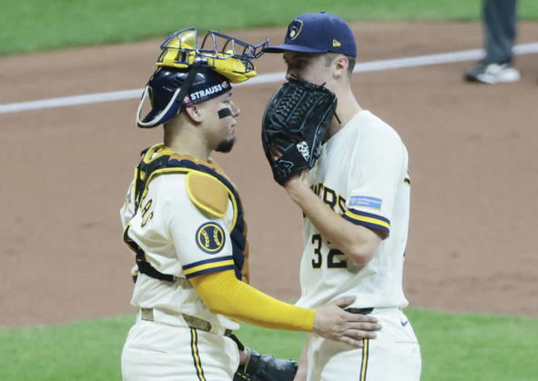 Milwaukee Brewers starting pitcher Jacob Misiorowski (32) has a mound visit with catcher William Contreras (24) with the bases loaded by the Los Angeles Dodgers in the second inning of an MLB, Baseball Herren, USA National League Championship Series playoff game at American Family Field in Milwaukee, Wisconsin, on Sunday, October 11, 2026.  MIL20261011706 TANNENxMAURY