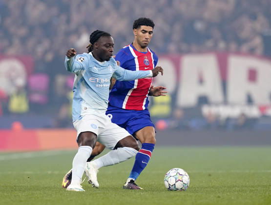 Manchester, England, 14th October 2026. Antoine Semenyo of Manchester City held up by Achraf Hakimi of Paris Saint-Germain during the Manchester City vs Paris Saint Germain UEFA Champions League match at the Etihad Stadium, Manchester. Picture credit should read: Andrew Yates Sportimage EDITORIAL USE ONLY. No use with unauthorised audio, video, data, fixture lists, club league logos or live services. Online in-match use limited to 120 images, no video emulation. No use in betting, games or single club league player publications. SPI_021_AY_Man_City_PSG SPI-5069-0021