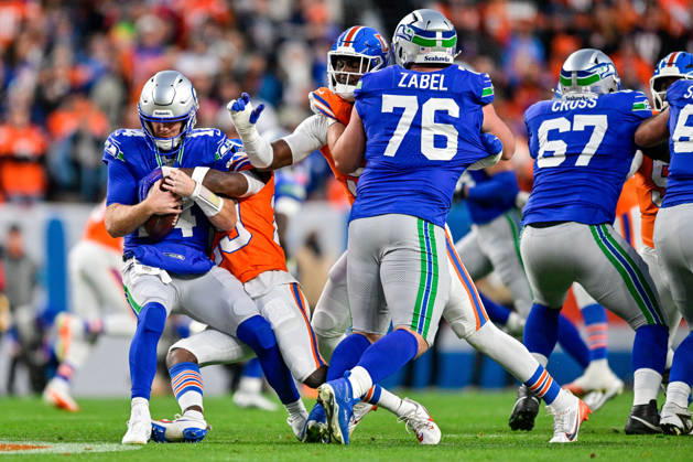 DENVER, CO - OCTOBER 15: Seattle Seahawks quarterback Sam Darnold (14) is sacked in the first quarter during a game between the Seattle Seahawks and the Denver Broncos at Empower Field at Mile High on October 15, 2026 in Denver, Colorado. (Photo by Dustin Bradford Icon Sportswire) NFL, American Football Herren, USA OCT 15 Seahawks at Broncos EDITORIAL USE ONLY Icon132261015019