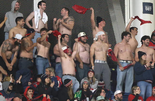 Shirtless Cleveland Guardians fans cheer for their team as they play the Tampa Bay Rays in game four of the MLB, Baseball Herren, USA American League Championship Series at Progressive Field in Cleveland, Ohio, on Saturday, October 17, 2026.  CLE20261017738 AARONxJOSEFCZYK