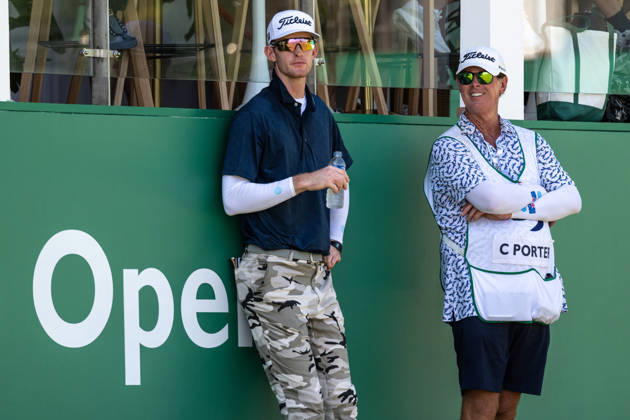 October 18, 2026, Macau, Macao Sar, China: Charles PORTER from the USA takes the tied lead on -14 Par with a stunning -9 Par final round. PORTER and his caddy hide from the heat in the shade of the hospitality stand on the 18th green. Macau Open Golf 2026 Final Round. Macau China - ZUMAr144 20261018_zap_r144_043 Copyright: xJaynexRussellx