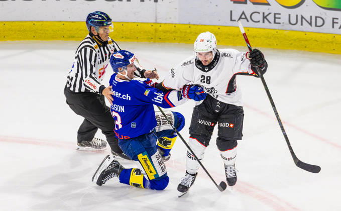 Ice hockey, Eishockey National League Regular Season - EHC Kloten vs Lausan Kloten, Switzerland, 20th Oct 2026: 28 Axel Simic (Lausanne) clashes with 23 Simon Johansson (Kloten). Linesman 79 David Obwegeser intervenes. Copyright: xAndreasxHaasx