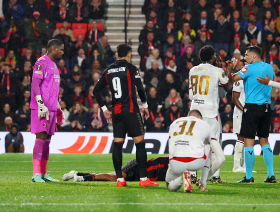 Bournemouth, England, 22nd October 2026. Mike Maignan of AC Milan stares at Tyler Adams of Bournemouth lying on the ground after he pushed him in the face during the AFC Bournemouth vs AC Milan UEFA Europa League match at the Vitality Stadium, Bournemouth. Picture credit should read: Paul Terry Sportimage EDITORIAL USE ONLY. No use with unauthorised audio, video, data, fixture lists, club league logos or live services. Online in-match use limited to 120 images, no video emulation. No use in betting, games or single club league player publications. SPI_036_PT_Bournmouthmouth_AC_Milan SPI-5092-0036