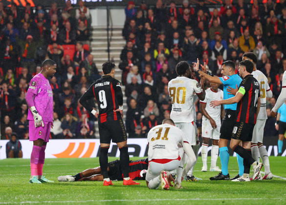 Bournemouth, England, 22nd October 2026. Referee Vassilis Fotias brandishes a red card to Mike Maignan of AC Milan after he pushed Tyler Adams of Bournemouth in the face during the AFC Bournemouth vs AC Milan UEFA Europa League match at the Vitality Stadium, Bournemouth. Picture credit should read: Paul Terry Sportimage EDITORIAL USE ONLY. No use with unauthorised audio, video, data, fixture lists, club league logos or live services. Online in-match use limited to 120 images, no video emulation. No use in betting, games or single club league player publications. SPI_039_PT_Bournmouthmouth_AC_Milan SPI-5092-0039