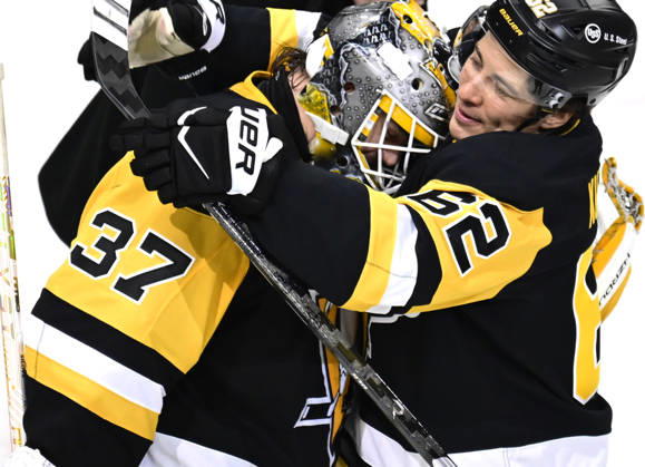 Pittsburgh Penguins goaltender Arturs Silovs (37) celebrates the Pittsburgh Penguins 4-0 win against the Florida Panthers with Pittsburgh Penguins left wing Andrei Kuzmenko (62) at PPG Paints Arena in Pittsburgh on Thursday, October 22, 2026. Pittsburgh Penguins goaltender Arturs Silovs (37) recorded 26 saves in the win.  PIT2026102214 ARCHIExCARPENTER