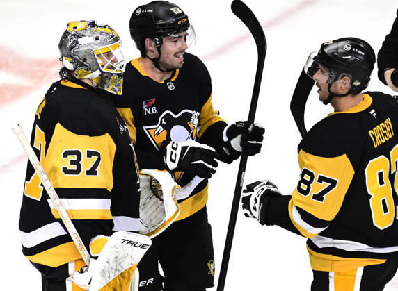Pittsburgh Penguins goaltender Arturs Silovs (37) celebrates the Penguins 4-0 win against the Florida Panthers with Pittsburgh Penguins center Hendrix Lapierre (22) and Pittsburgh Penguins center Sidney Crosby (87) at PPG Paints Arena in Pittsburgh on Thursday, October 22, 2026. Pittsburgh Penguins goaltender Arturs Silovs (37) recorded 26 saves in the win.  PIT2026102215 ARCHIExCARPENTER