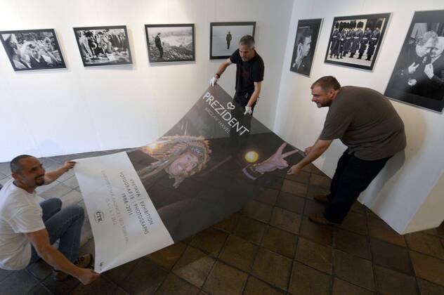CTK Photobank Editor in Chief Petr Mlch (left to right) and photographers Michal Kamaryt and Stanislav Zbynek pose with the poster before the exhibition President Vaclav Havel opening in Prague Thursday, June 14, 2012. Photographs of Vaclav Havel (1936-2011) taken by CTK reporters, mainly from the time of his presidency, are displayed in Prague s Old Town Hall. (CTKxPhoto RomanxVondrous) CTKPhoto031201206140684401