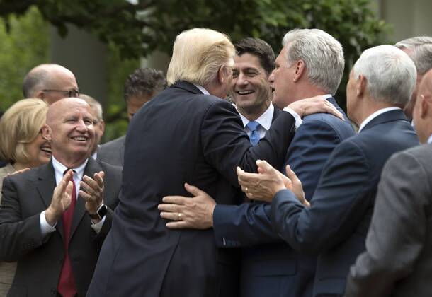 President Donald Trump embraces Speaker of the House Paul Ryan, R-Wis. (L) and House Majority Leader Kevin McCarthy, R-Calif., during a press event celebrating the House passage of Republican legislation to roll back the Affordable Care Act, at the White House in Washington, D.C. on May 4, 2017. The American Health Care Act passed the House with a vote of 217-213 vote. It will next move to the Senate. WAP20170504331 KEVINxDIETSCH