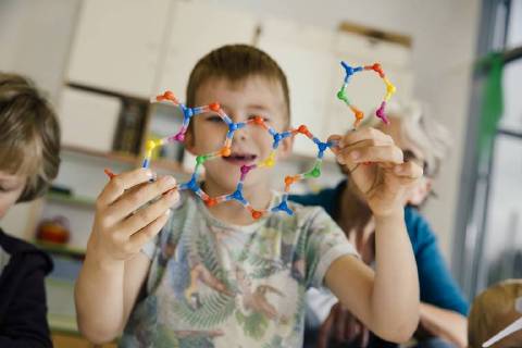 Boy holding dna helix model in kindergarten model released Symbolfoto property released  MFF04128
