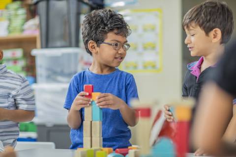 Boys talking and playing with building blocks in kindergarten model released Symbolfoto property released  ZEF15436