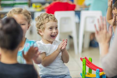 Happy children and pre-school teacher clapping hands in kindergarten model released Symbolfoto property released  ZEF15442