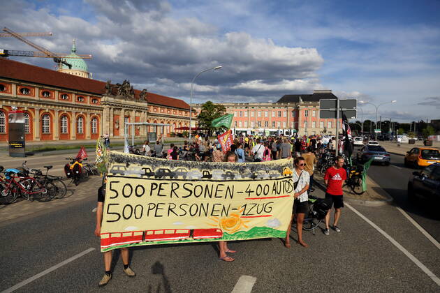 Demonstranten stehen mit Banner 500 Personen 400 Autos 500 Personen 1 Zug auf der Breiten Straße im Rahmen der Students for Future Fahrraddemo Ohne Kerosin nach Berlin bei einem Zwischenstopp in Potsdam, 31. August 2022. Students for Future Ohne Kerosin nach Berlin