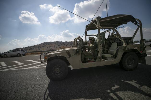 (231017) -- JERUSALEM, Oct. 17, 2023 -- This photo taken on Oct. 16, 2023 shows an Israeli soldier on a military vehicle running on a road near the Israeli-Lebanese border in northern Israel. The Israeli-Lebanese border has seen an escalation of tensions since last week as Hezbollah fired tens of rockets at Israeli military sites on Oct. 8 in support of an onslaught by the Gaza-ruling Palestinian Islamic Resistance Movement (Hamas) on Israel on Oct. 7. Hezbollah on Monday announced that it targeted five Israeli sites with rocket-propelled grenades and machine guns and inflicted Israeli injuries, to which Israel responded by firing seven missiles toward Hezbollah positions in the border town of Rmeish and shelling several Lebanese areas. )