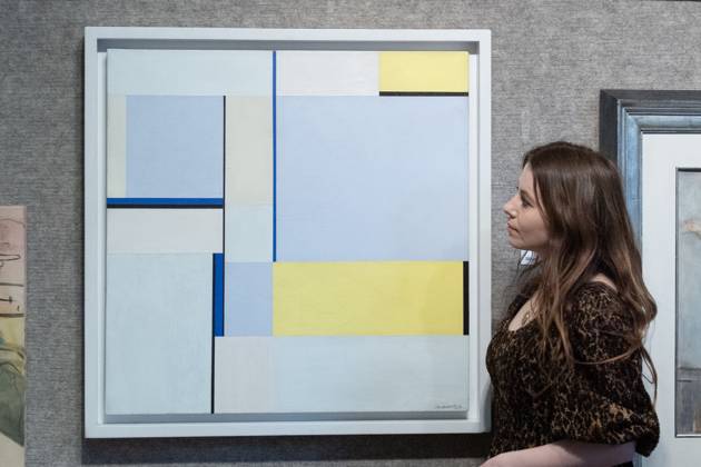 Bonhams 20th 21st Century Art Day Evening Sales Highlights Photocall - Bonhams, London A staff member views Square in 3 Blues (79-109) by Ilya Bolotowsky (est £10k -£15k) which is to go on auction at Bonhams 20th 21st Century Art Day Evening Sales at Bonhams in London, England, UK on Monday 31 March, 2025., Credit:Justin Ng Avalon UK, England, London, Bonhams Copyright: xJustinxNgx xAvalonx 0981806181