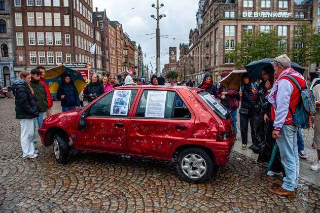 October 5, 2025, Amsterdam, North Holland, Netherlands: People are seen surrounding the car full of bullets. A vehicle representing five-year-old Hind Rajab and her family, who were killed during an Israeli army attack in the Tel al-Hawa area of Gaza in January 2024, has been exhibited in the Netherlands. Amsterdam Netherlands - ZUMAs197 20251005_aaa_s197_615 Copyright: xAnaxFernandezx
