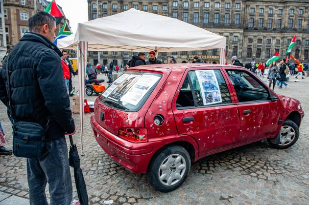 October 5, 2025, Amsterdam, North Holland, Netherlands: A man observing the car full of bullets. A vehicle representing five-year-old Hind Rajab and her family, who were killed during an Israeli army attack in the Tel al-Hawa area of Gaza in January 2024, has been exhibited in the Netherlands. Amsterdam Netherlands - ZUMAs197 20251005_aaa_s197_617 Copyright: xAnaxFernandezx