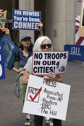 October 7, 2025, New York, New York, USA: Demonstrators denouncing Fox News as extremist right-wing propaganda in support of President Trump s administration hold signs that read NO TROOPS IN OUR CITIES! with an image of the Statue of Liberty PRESS FACT check Associated Press AP Reuters BBC The Hill FOX VIEWERS You ve been CONNED outside of News Corp s Fox News Channel in midtown Manhattan. Protesters with the activist groups Rise & Resist and Truth Tuesdays come to Fox News weekly for a peaceful demonstration calling for truth in journalism and denouncing authoritarianism, oligarchy, fascism, and Trump s agenda. New York USA - ZUMAr174 20251007_znp_r174_007 Copyright: xGinaxMxRandazzox