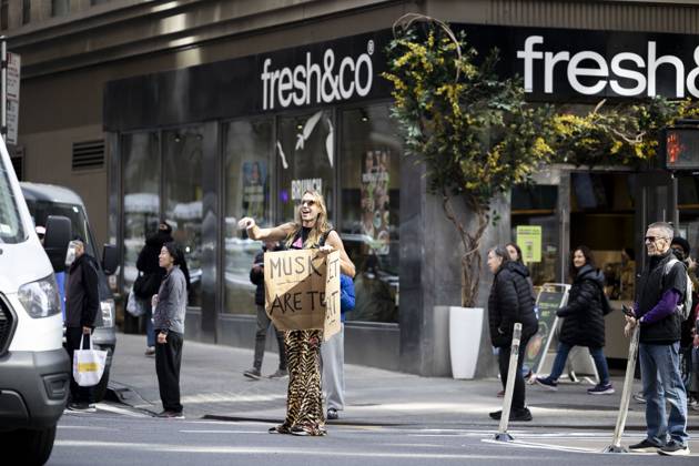 October 18, 2025, New York, New York, USA: A protester holds a sign. Demonstrators fill streets across cities and towns nationwide during the â€oeNo Kings†protest, denouncing the policies of the Trump administration. New York USA - ZUMAh182 20251018_znp_h182_011 Copyright: xMatthewxHoenx