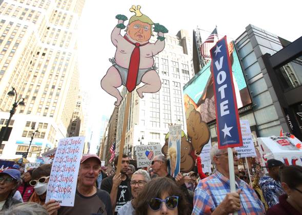 October 18, 2025, New York City, New York, USA: A man holds a sign during the No Kings protest in New York City on Oct. 18, 2025. Tens of thousands of people hit New York City streets to protest Donald Trump, autocracy, ICE and immigrant deportations. More than 2,500 similar protests took place nationwide. New York City USA - ZUMAk45_ 20251018_zaf_k45_037 Copyright: xKristaxKennellx