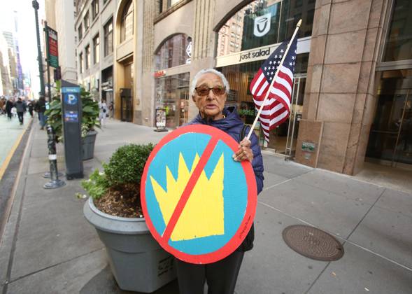 October 18, 2025, New York City, New York, USA: A woman holds a sign and an American Flag during the No Kings protest in New York City on Oct. 18, 2025. Tens of thousands of people hit New York City streets to protest Donald Trump, autocracy, ICE and immigrant deportations. More than 2,500 similar protests took place nationwide. New York City USA - ZUMAk45_ 20251018_zaf_k45_041 Copyright: xKristaxKennellx