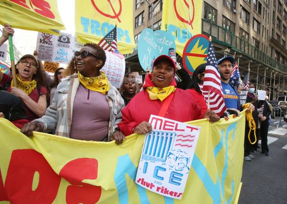 October 18, 2025, New York City, New York, USA: A woman holds a sign that says Melt ICE and shut Rikers during the No Kings protest in New York City on Oct. 18, 2025. Tens of thousands of people hit New York City streets to protest Donald Trump, autocracy, ICE and immigrant deportations. More than 2,500 similar protests took place nationwide. New York City USA - ZUMAk45_ 20251018_zaf_k45_046 Copyright: xKristaxKennellx